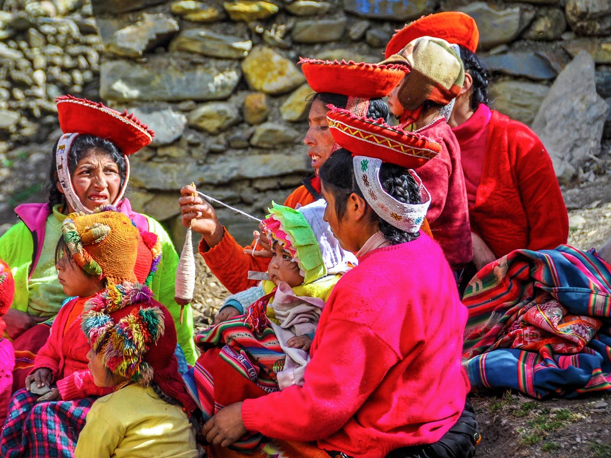 Quechua women dressed in colorful clothing on Lares Trek to Machu Picchu near Cusco Peru