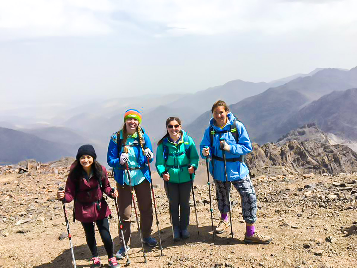 4 female hikers posing on Villages Valleys and Mt Toubkal Climb tour in Morocco