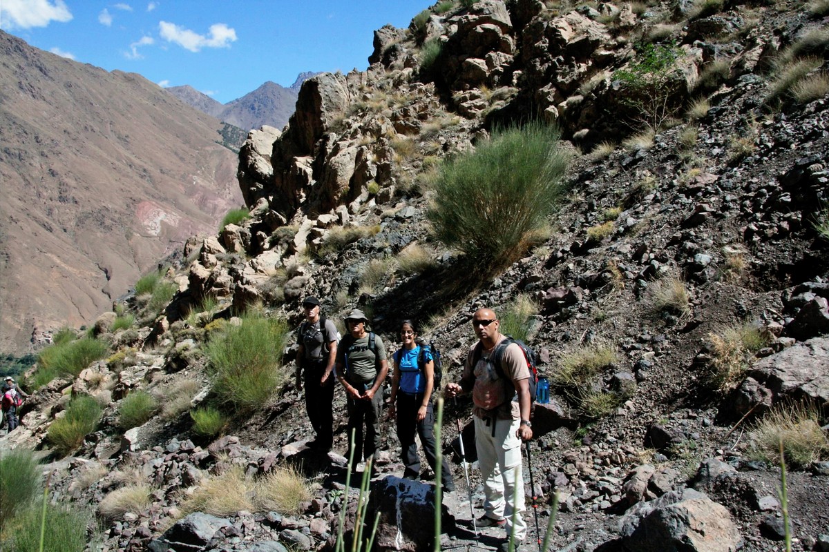 Group of hikers on a trail of guided trekking tour to Atlas Valley from Marrakech Morocco