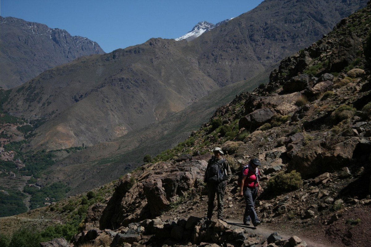 Two hikers surrounded by beautiful views on guided trekking tour to Atlas Valley from Marrakech Morocco