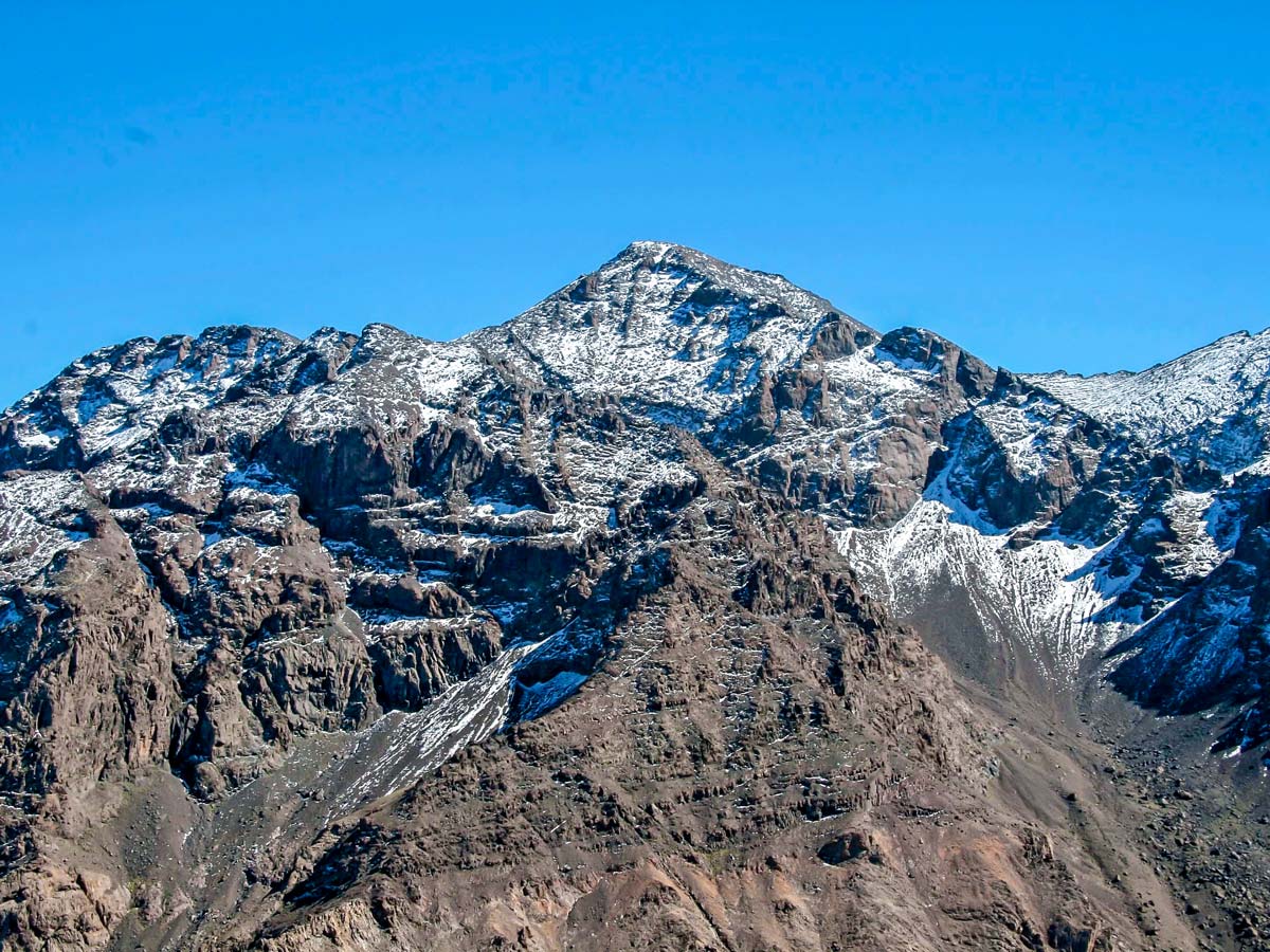 Snowy peaks surrounding the trail of Mt Toubkal Circuit Trek in Morocco