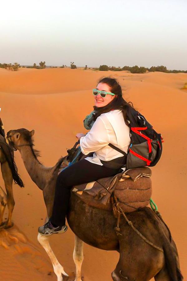 Trekker enjoying the camel ride on Merzouga Overland Tour in Morocco