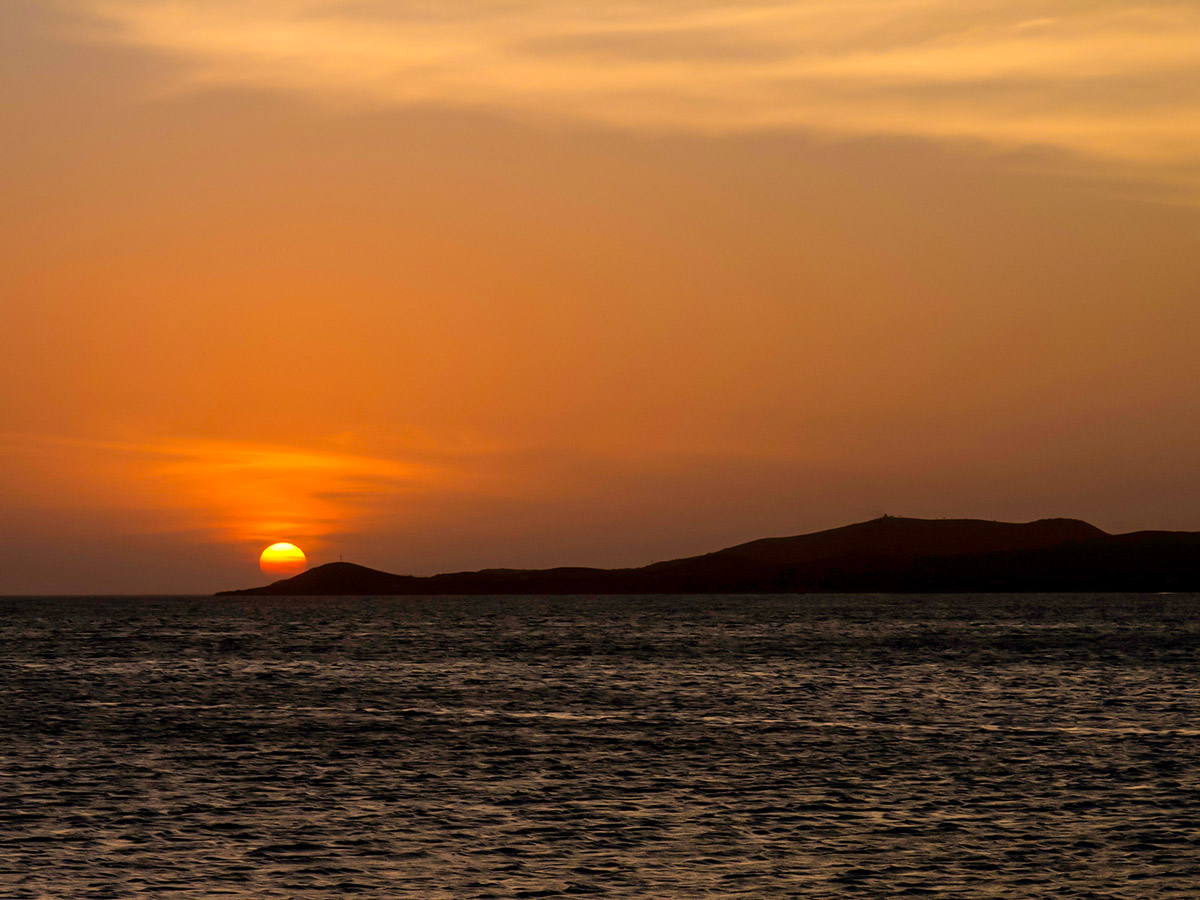 Sun setting in Atlantic Ocean on Colombia Off Road Tour in Colombia