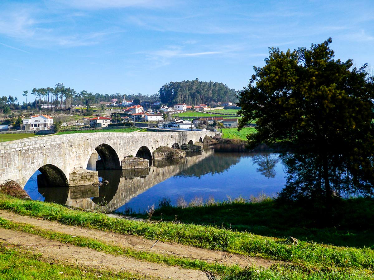 Spain Portugese Camino Biking Crossing the medieval bridge on Portugese Camino Biking Tour