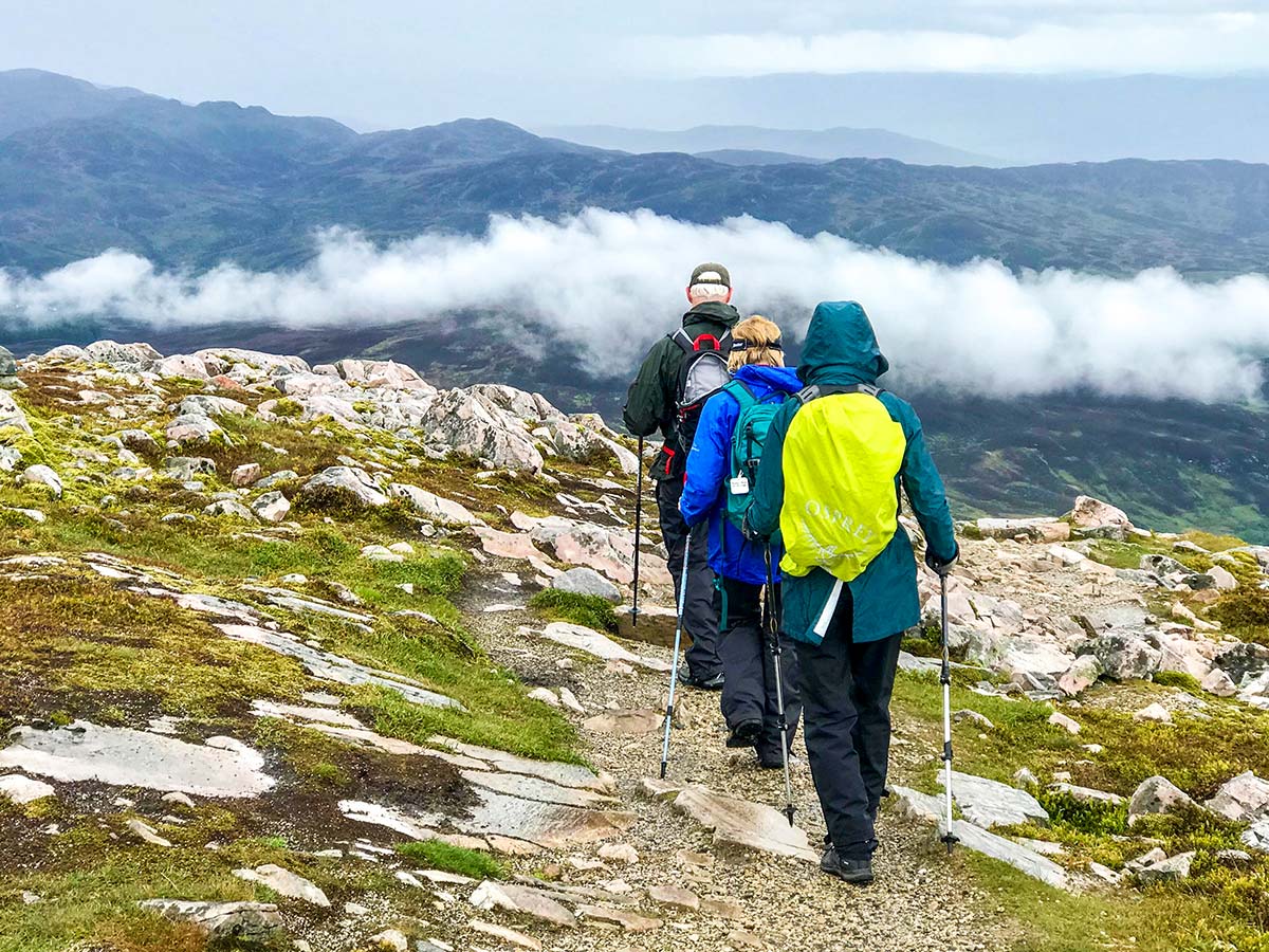 Group of walkers trekking on guided Glencoe and the Highlands walking tour in Scotland