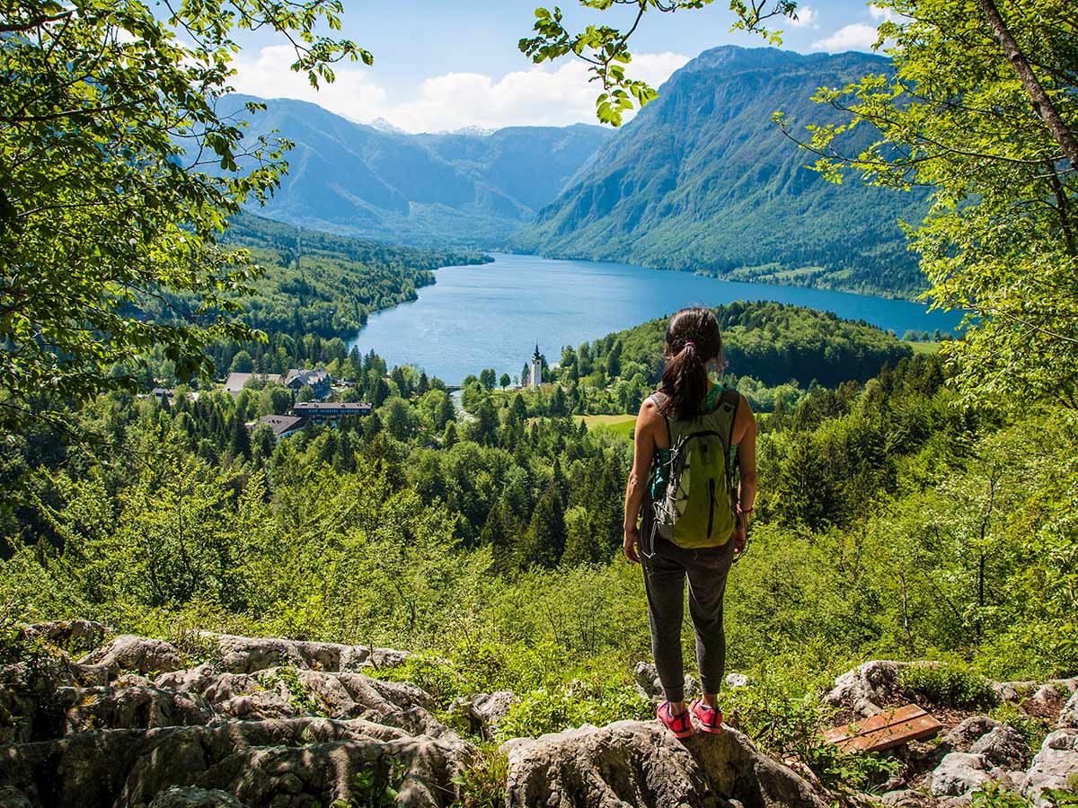 Hiker posing in front of the lake on Best Walks in Slovenia Tour with a guide