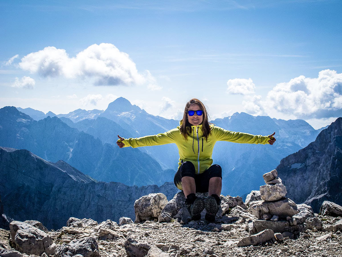 Happy hiker posing on the mountian on Discover Slovenian Alps Tour