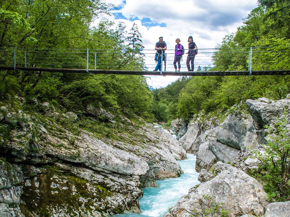 Crossing the turqoise creek in Slovenian Mountains