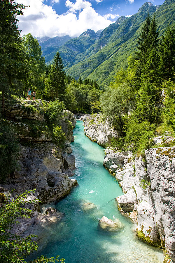 Blue creek surrounded by Slovenian Mountains