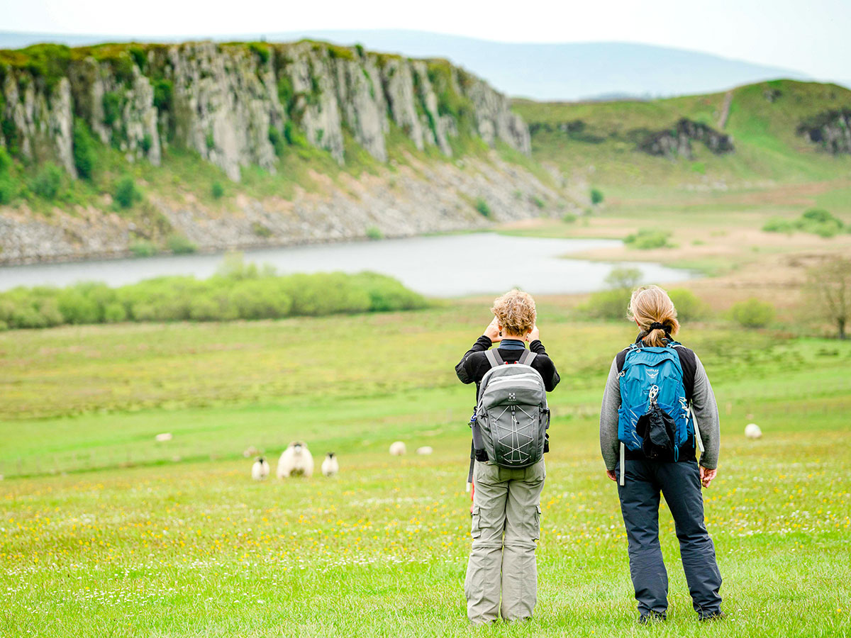 Two hikers observing the views on Northumberland and the Lake District guided walking tour