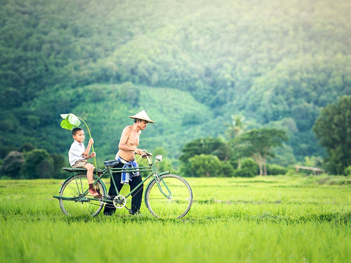 Father and son cycling seen on Northern Vietnam Mountain Biking Tour