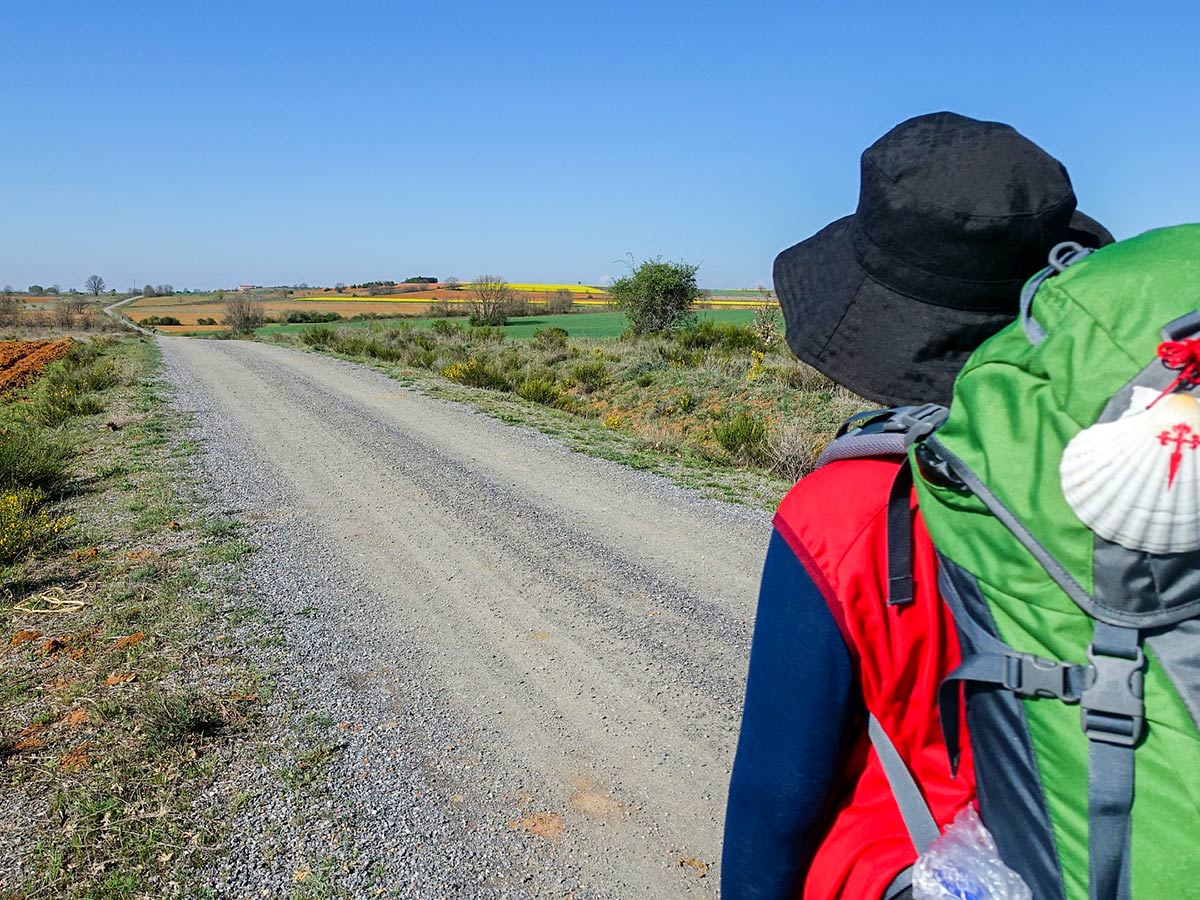 Hiker with green backpack on Camino de Santiago Portuguese Way