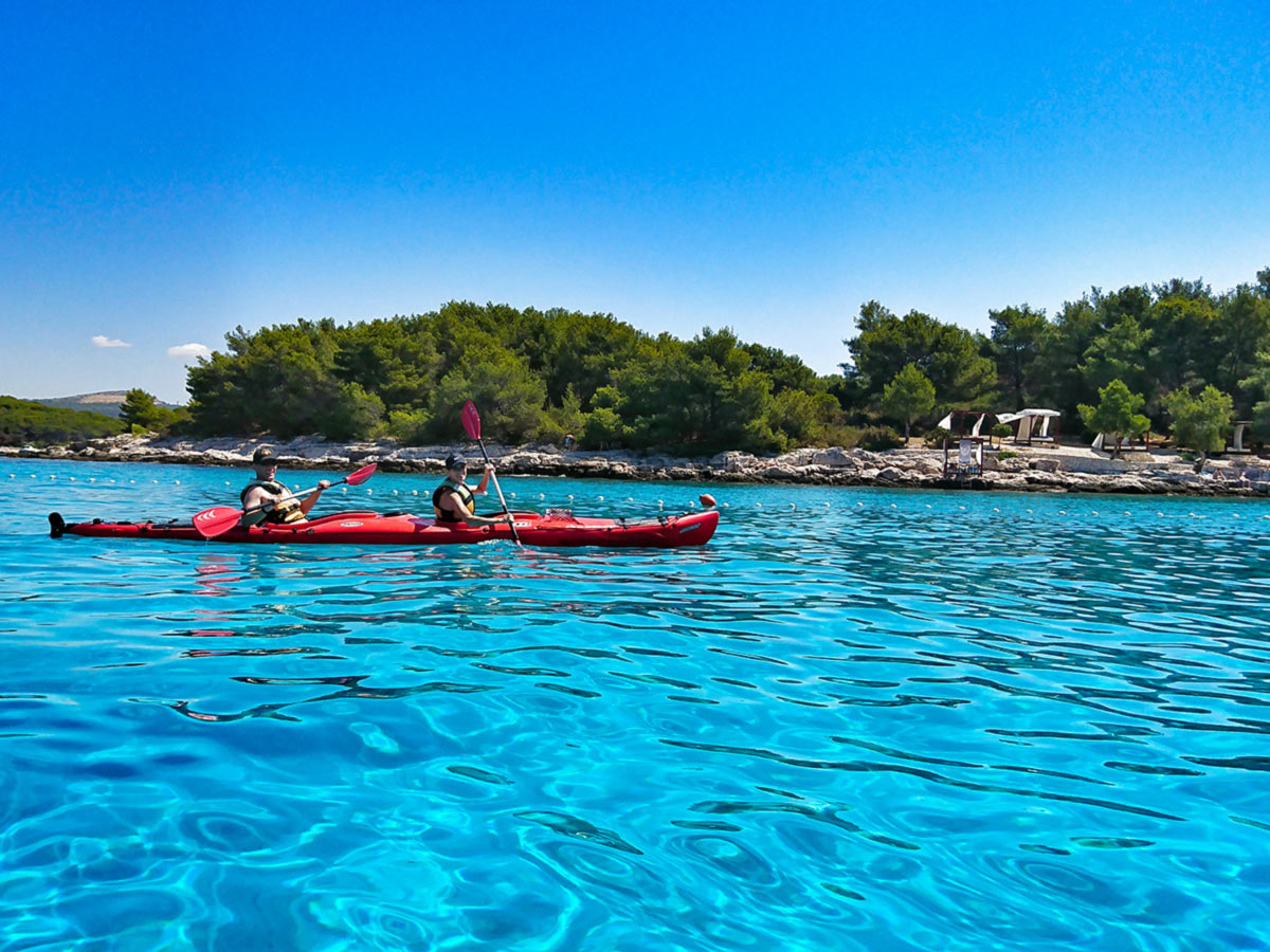 Turquose water and red kayak near Pakleni Islands Croatia