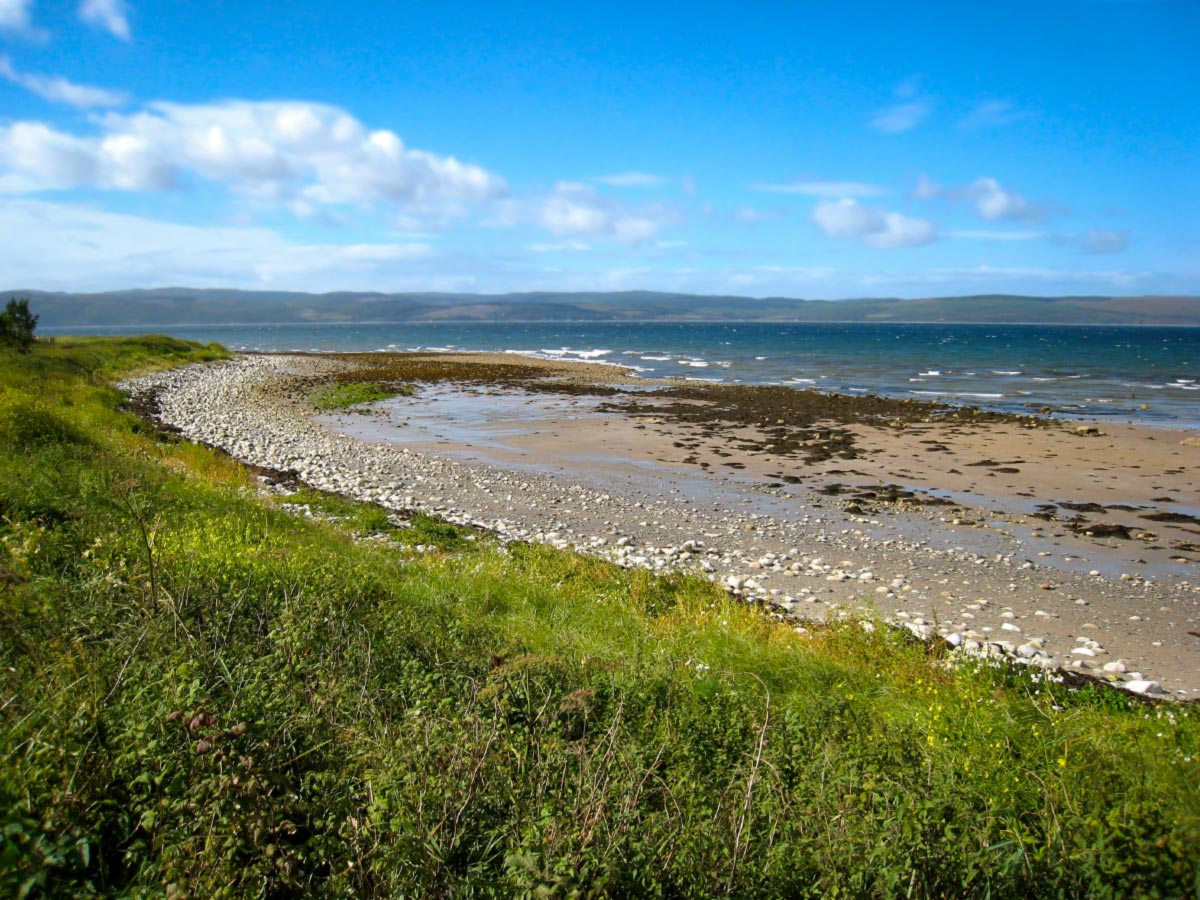 Blue skies and deserted coast on Clyde Islands Whiskey Tour in Scotland