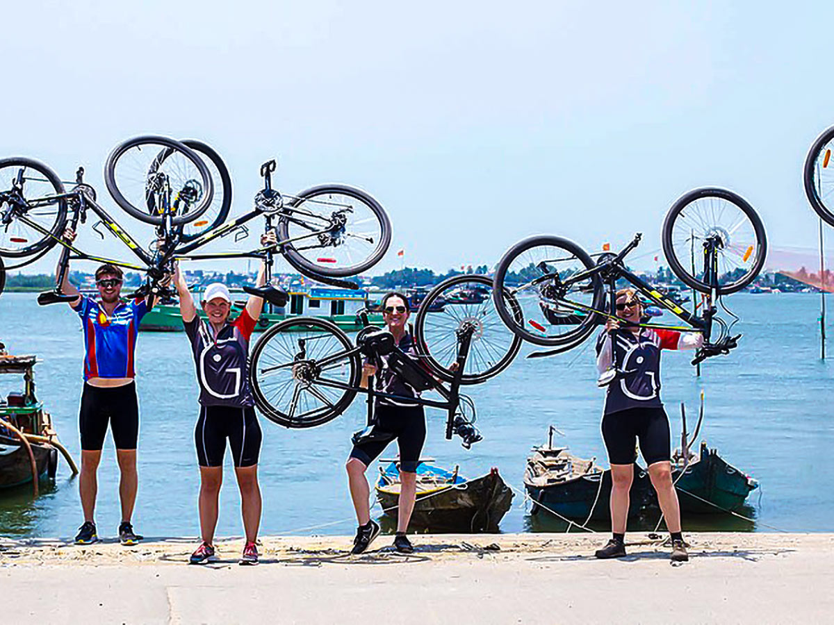 Group of bikers posing for picture on Coast of Vietnam Tour