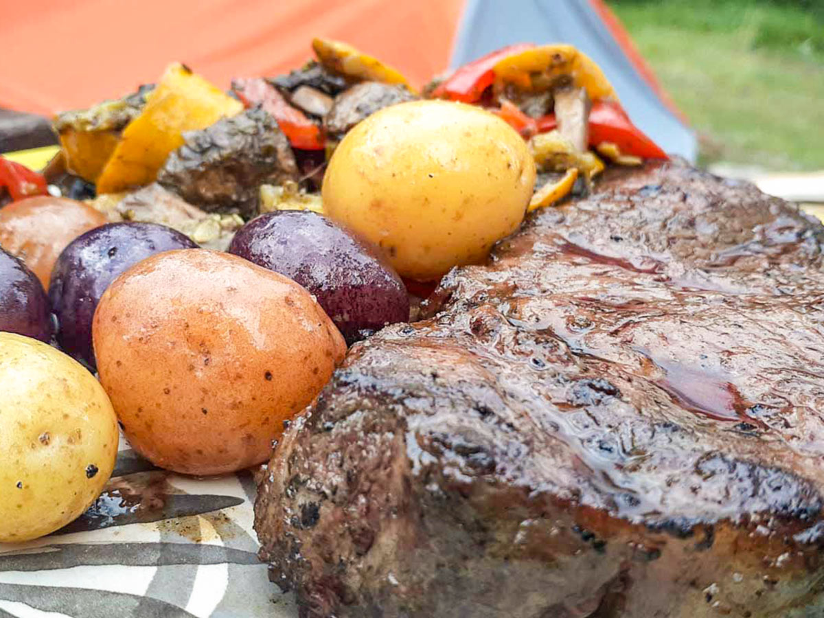 Steak dinner on a camping and hiking adventure tour in the Canadian Rocky Mountains