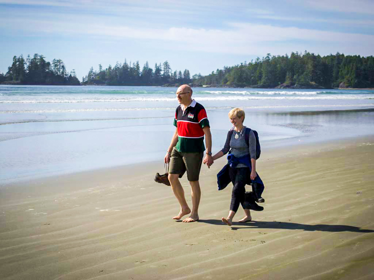 Couple walking along the beach on Vancouver Island