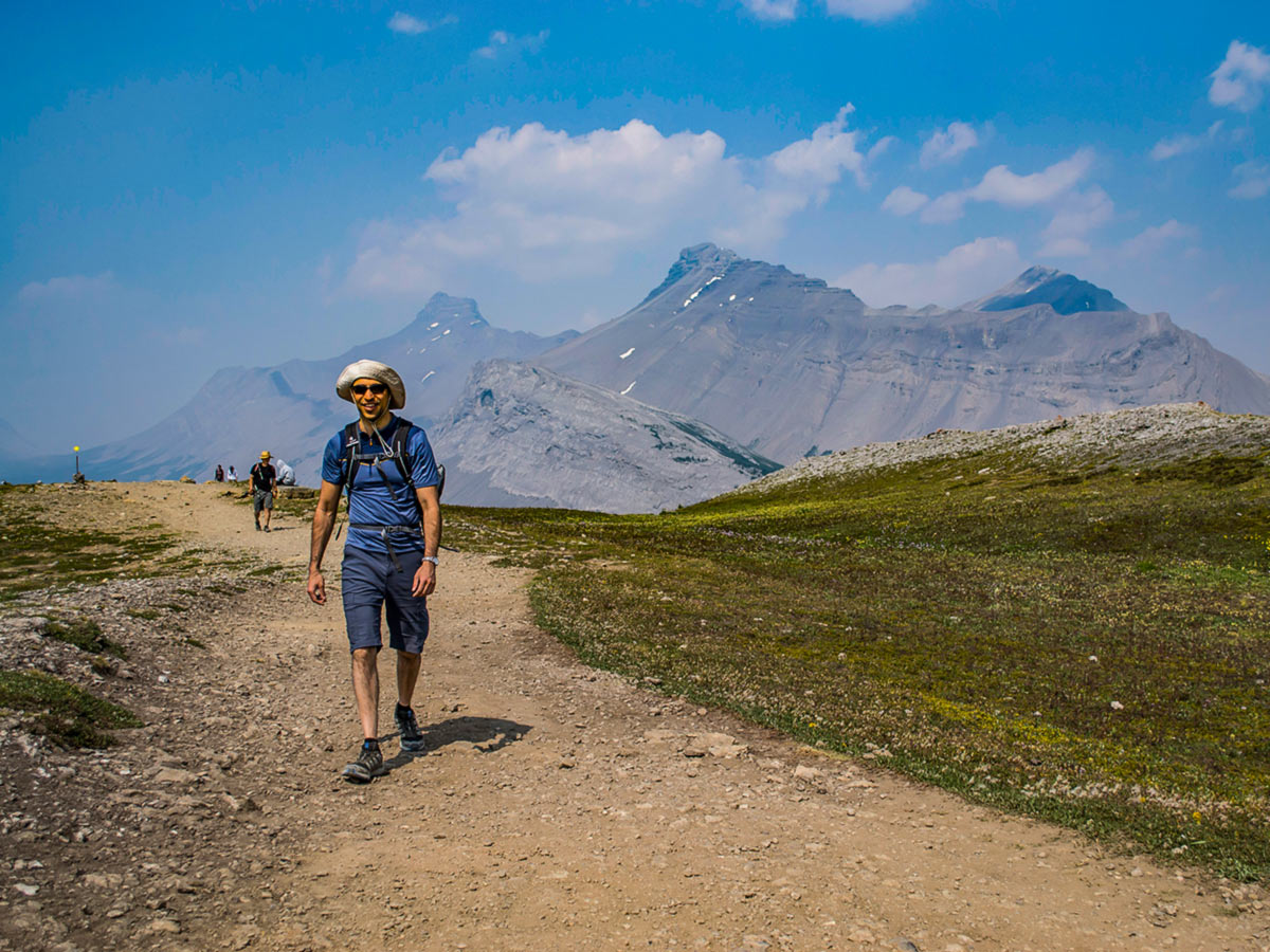 Happy hikers walking the train in the Canadian Rockies