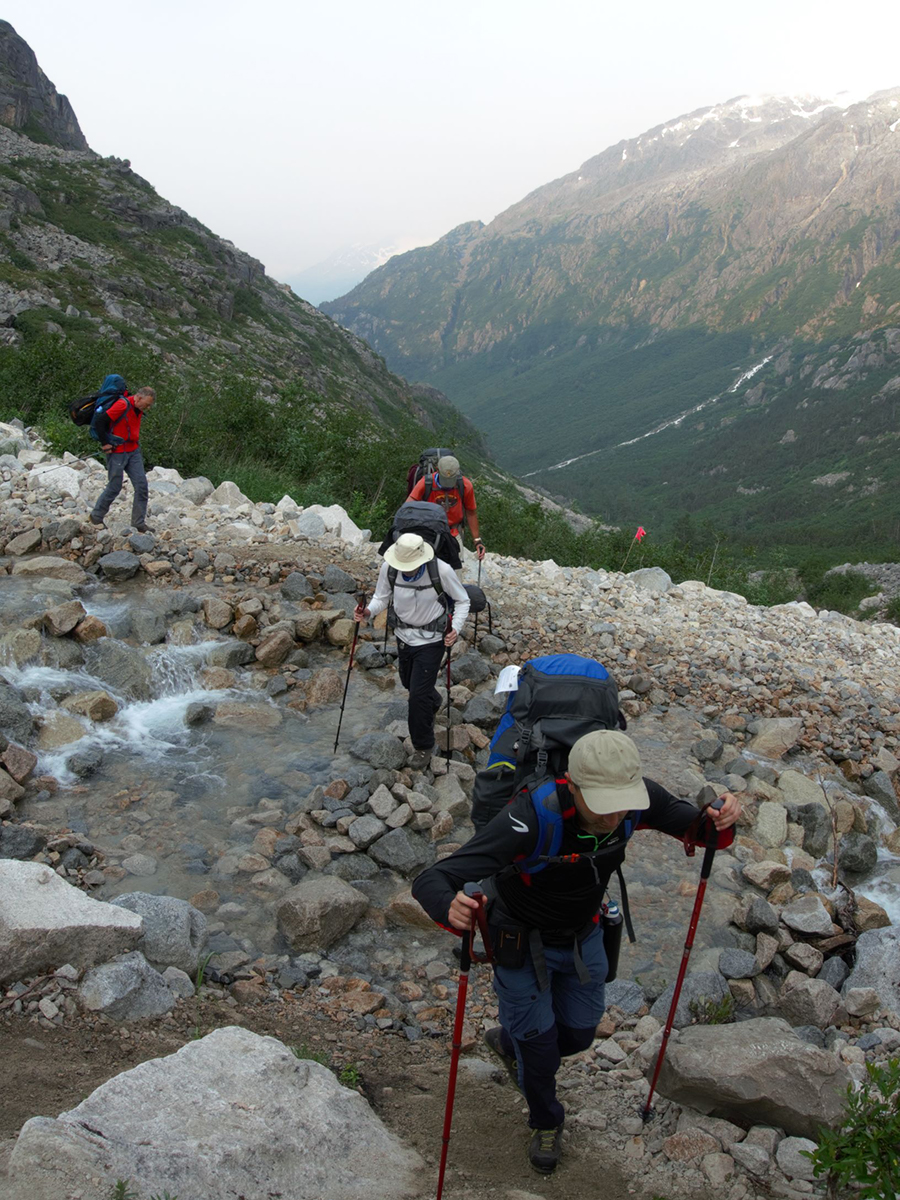 Crossing the alpine creek on Chilkoot Trail in Alaska and British Columbia