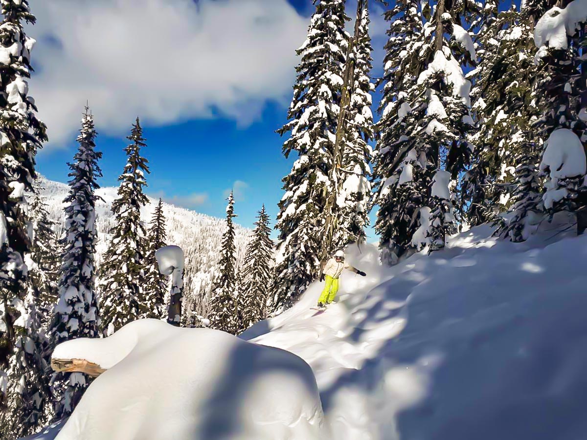 Snowboarder riding down on a snowed in mountain