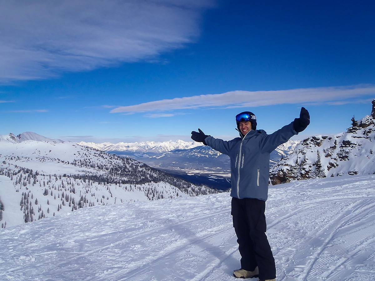 Skier posing on top of a snowy peak