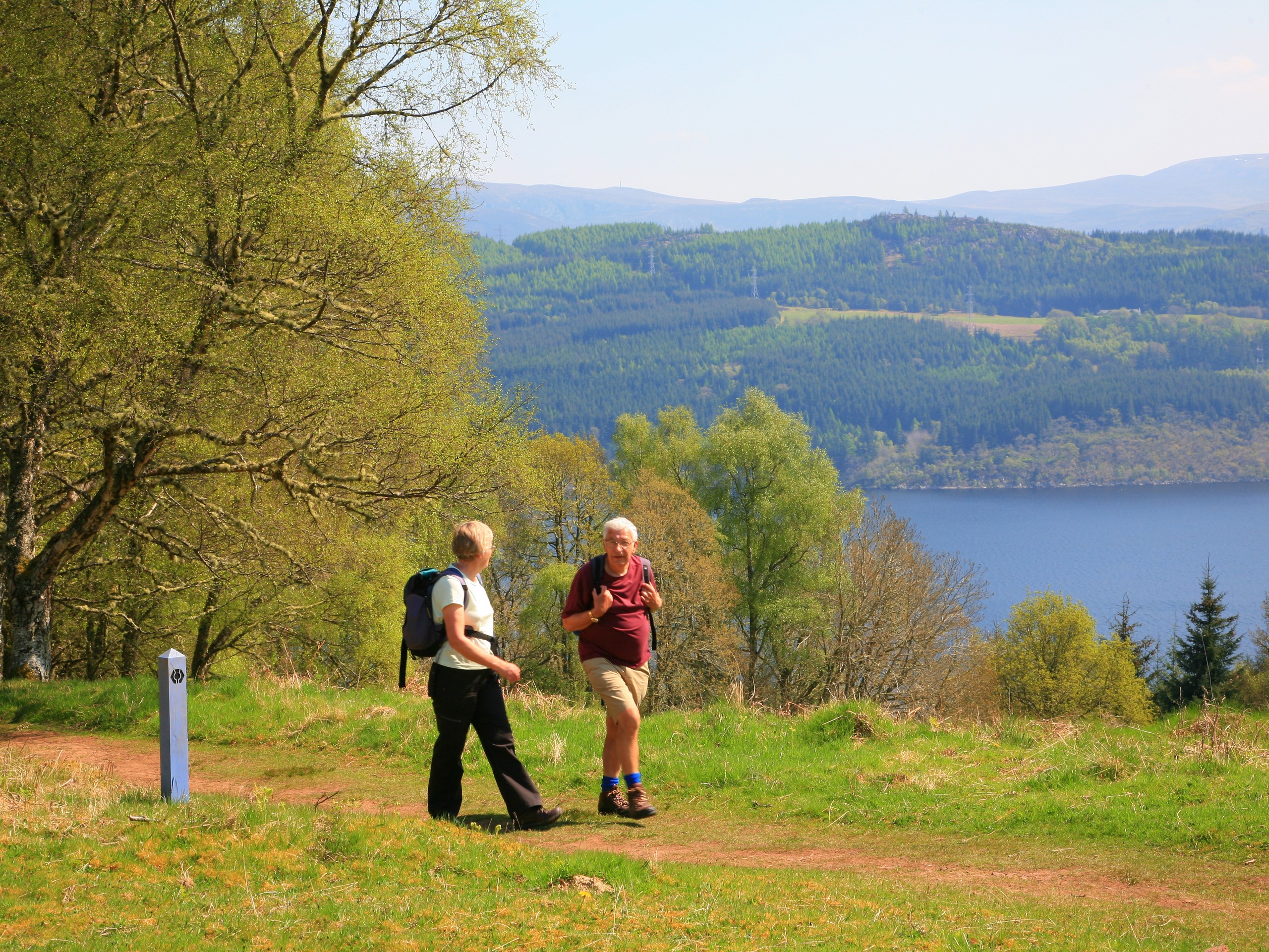 Two walkers and a lake behind them