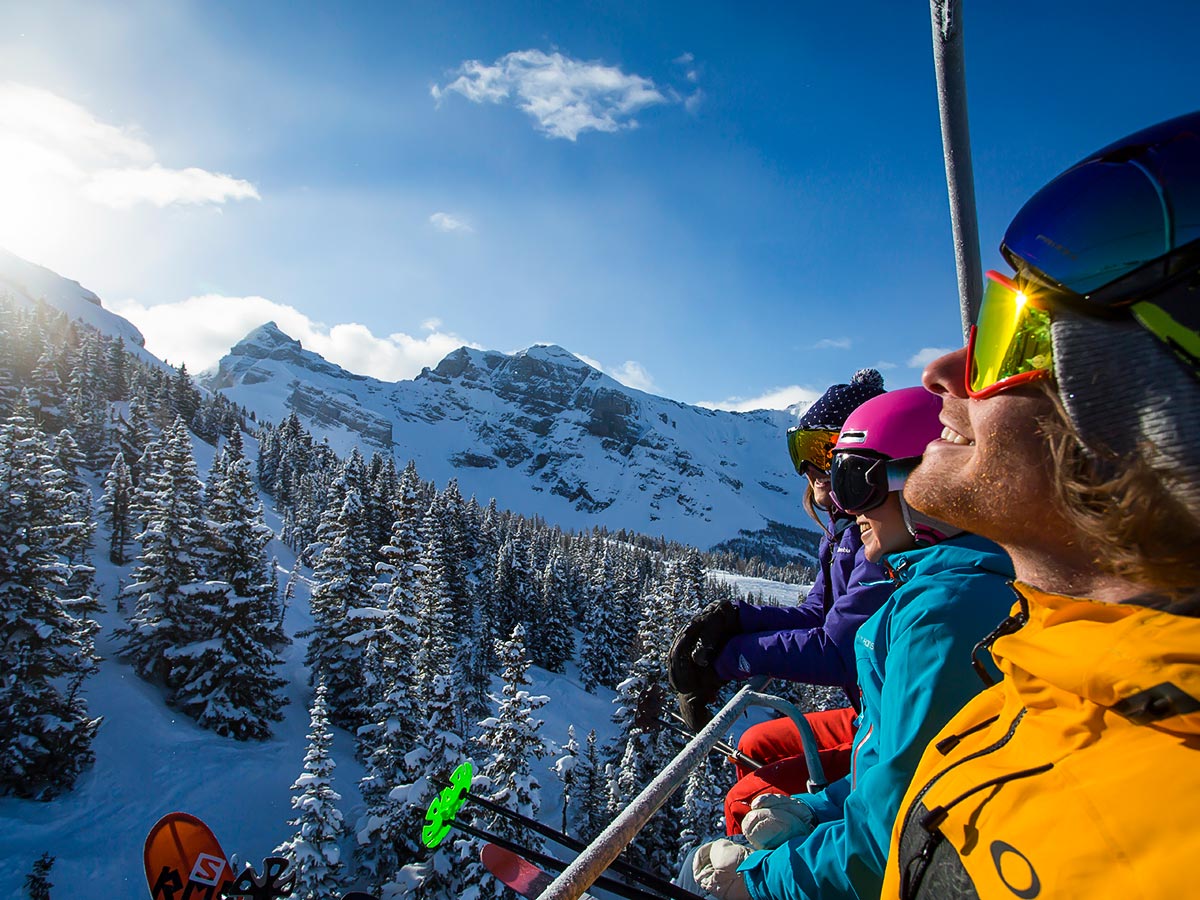 Riding the skiing lift up while on a skiing tour