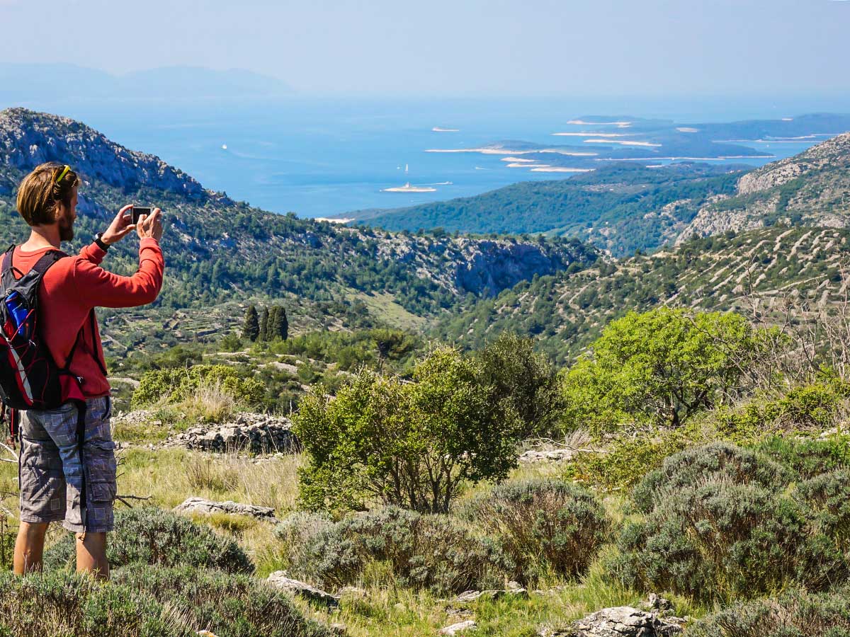 Hiker taking pictures of the stunning panorama between Split and Dubrovnik Croatia