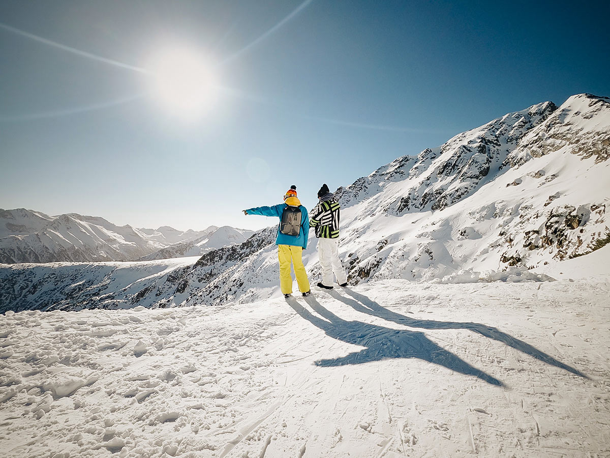 Two skiers admiring the views in Bulgarias snowy mountains