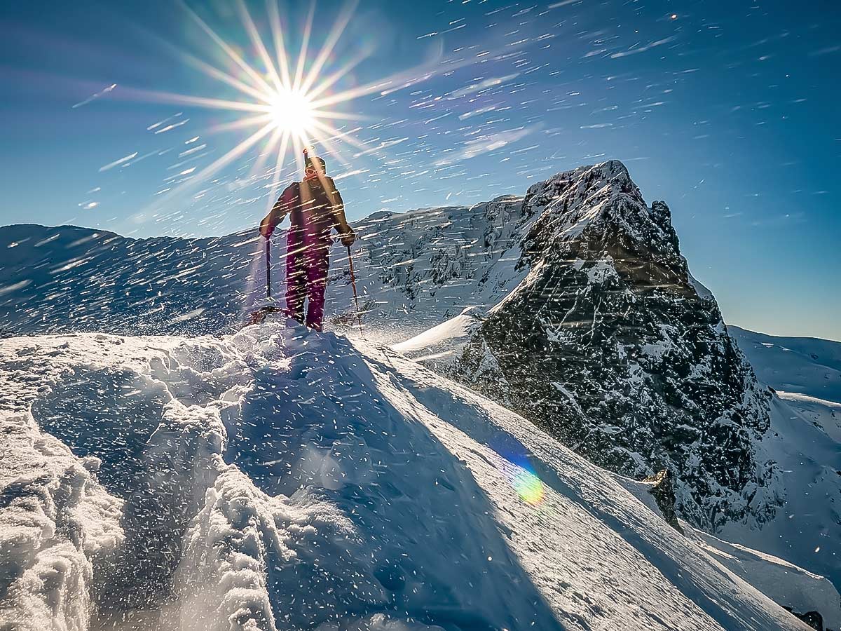 Snowshoer and the bright sun in the Bulgarias mountains