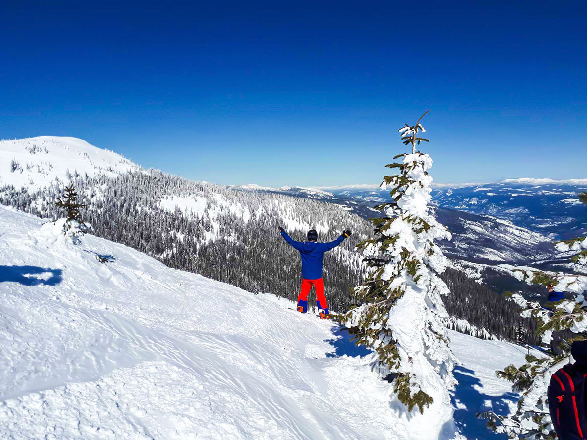 Skier posing in front of the mountain view in the British Colubian Mountain Resort