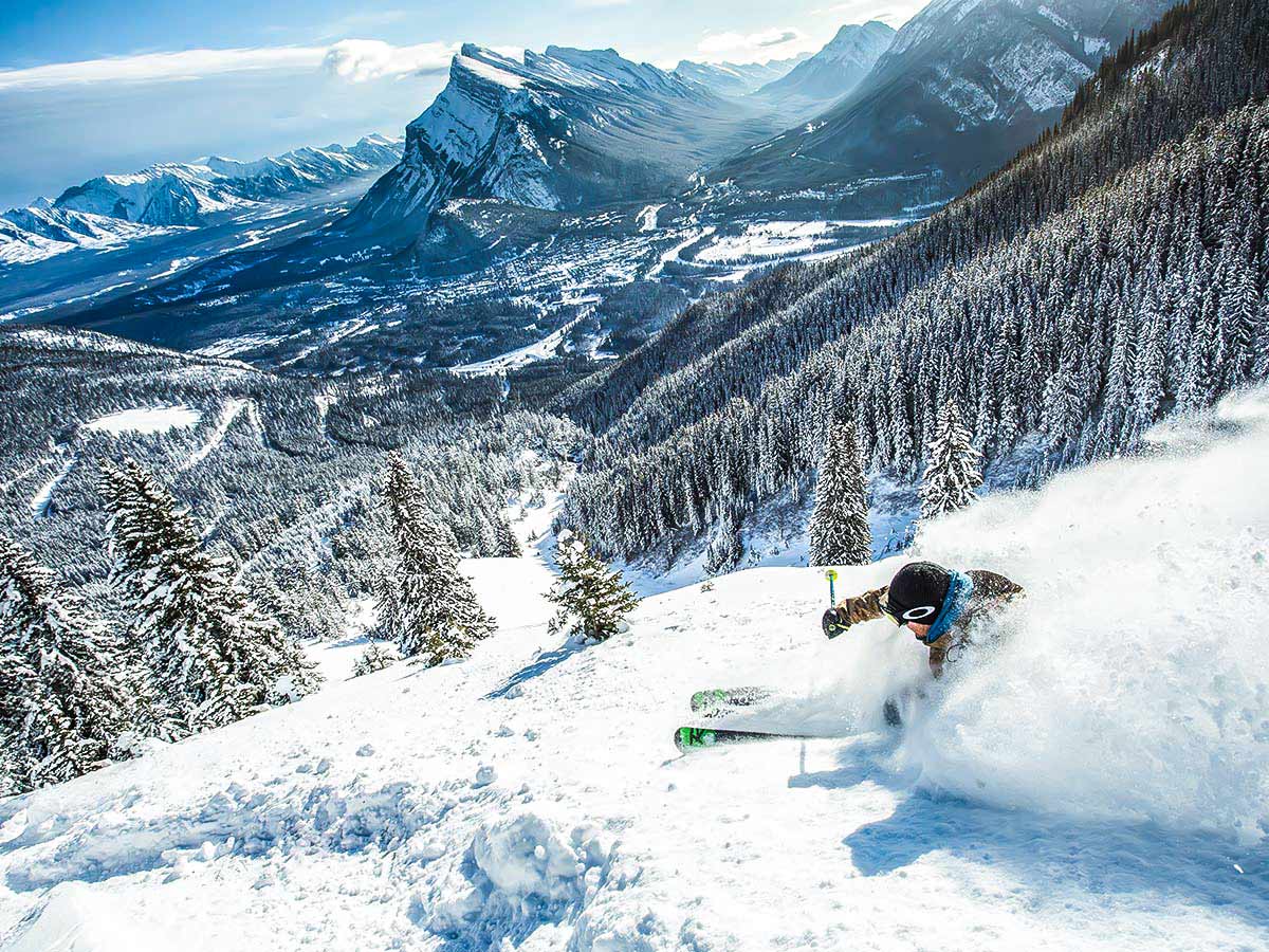 Skiing downhill in one of the British Columbias ski resorts on a guided tour