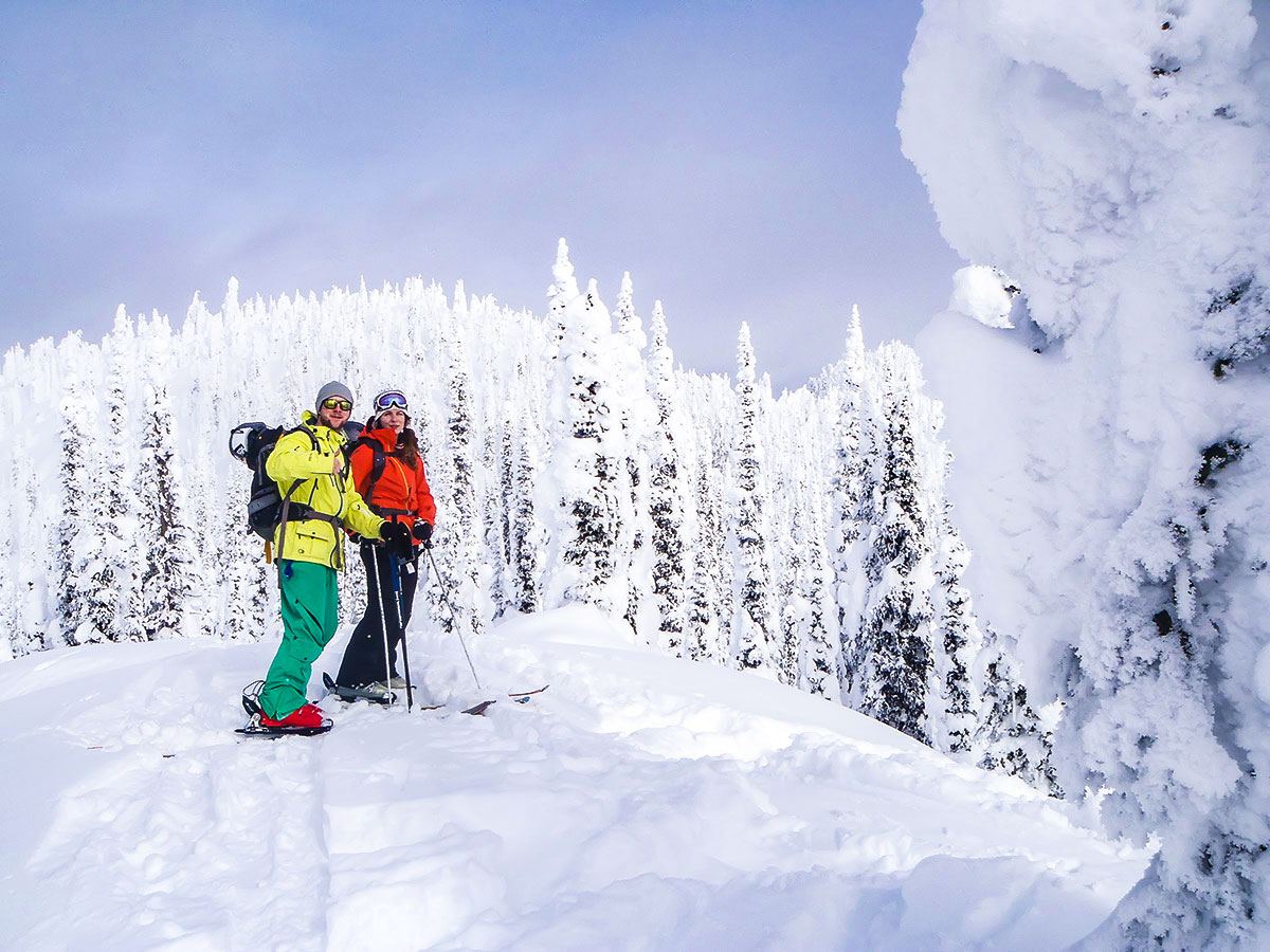 Couple enjoying the winter views on a guided backcountry ski tour