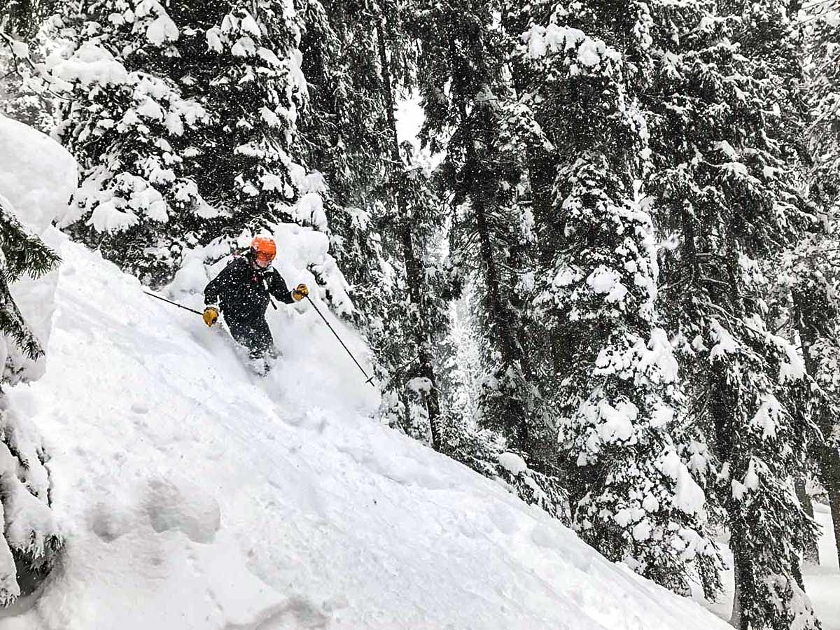 Skiing down the snowy mountain on a guided Backcountry Ski Tour in Canada