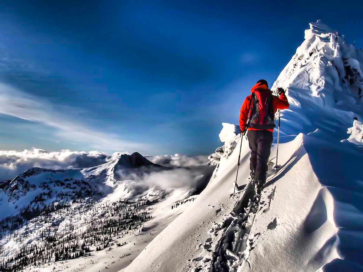 Ascending snowy peak on Backcountry Ski Tour in Canada with a guide