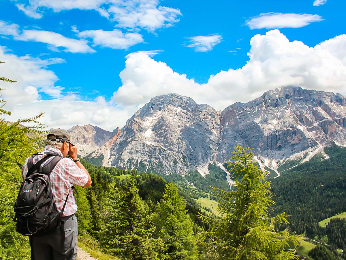 Hiker looking at Dolomite Mountains in Italy South Tyrol