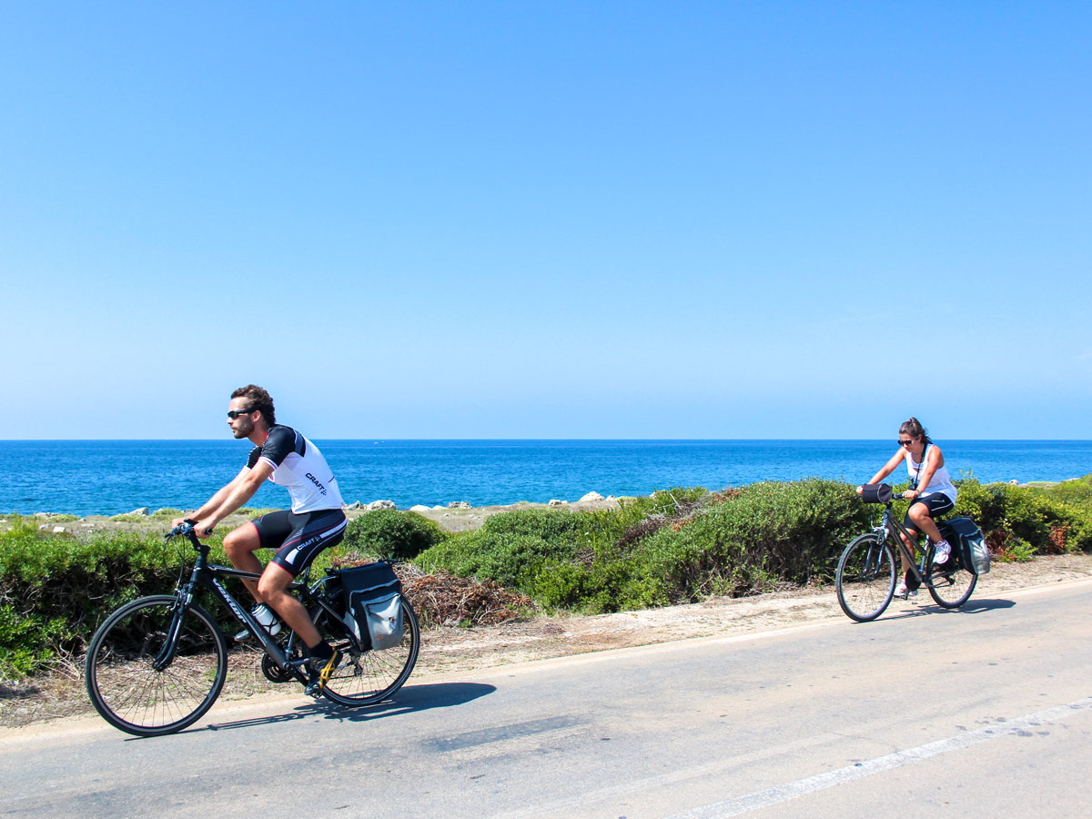 Bikers riding the windy road on self guided Puglia biking tour