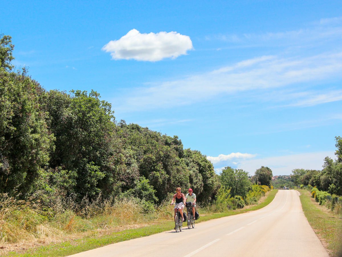Two bikers riding the path between Venice and Porec
