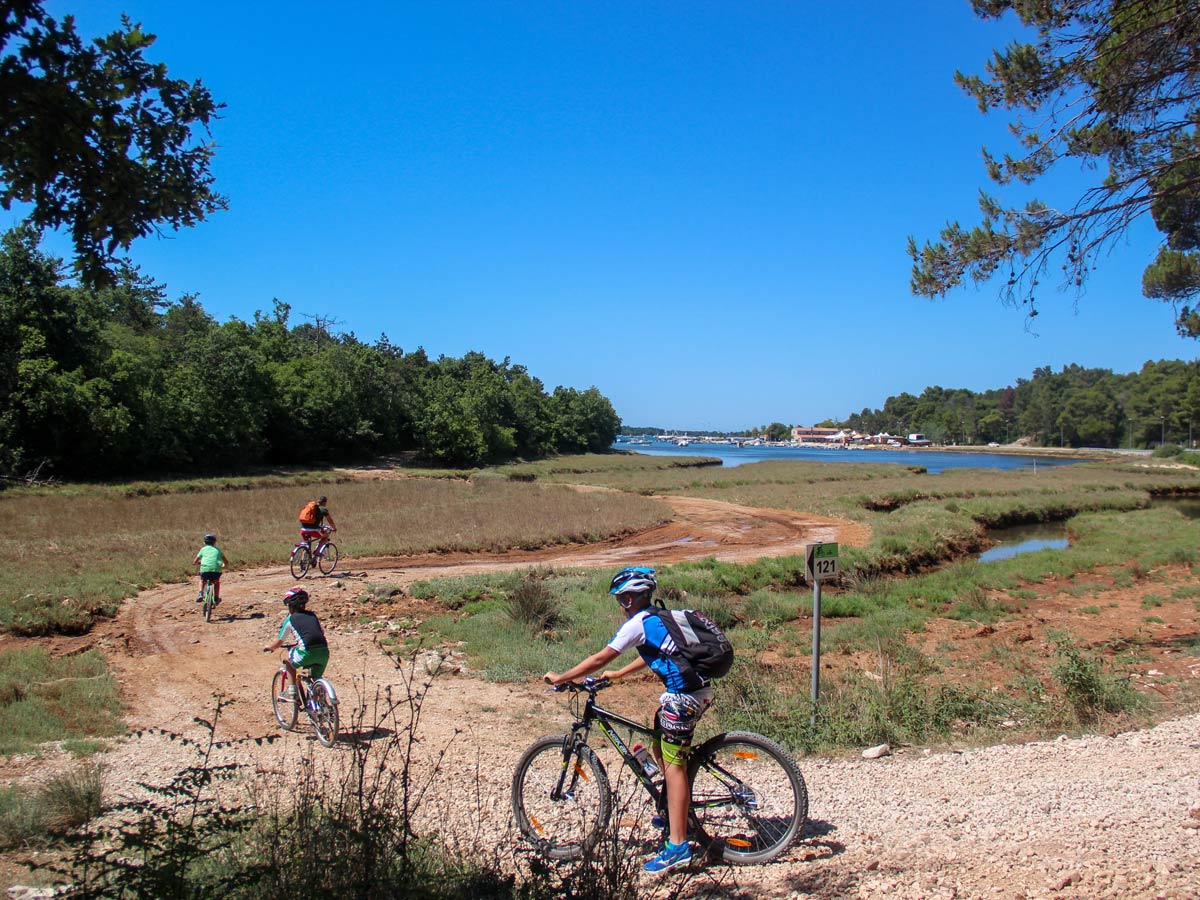 Bikers on the gravel path of self guided bike ride in Italy and Croatia