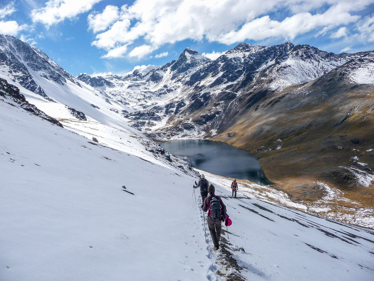 Hikers crossing the snowy pathon Condoriri and Tuni trek