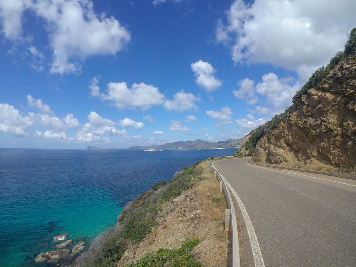 Biking along the blue Mediterranea Sea in Sardinia Island Italy