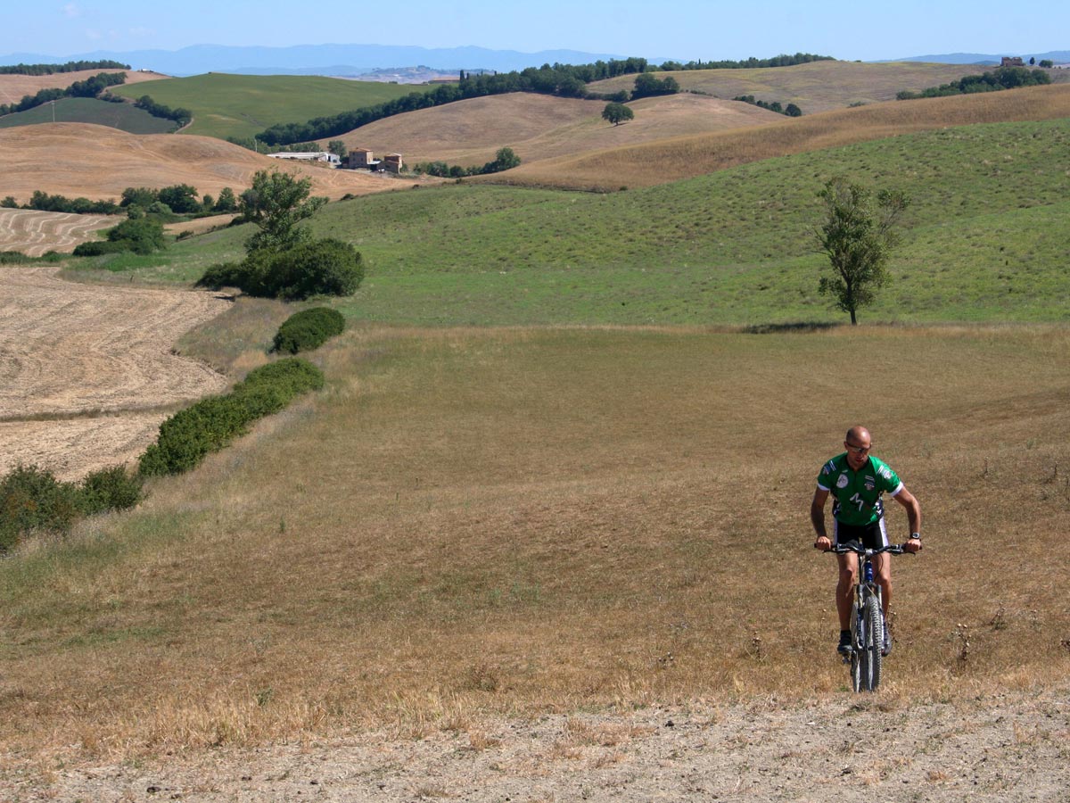 Biker cycling in Tuscany Val dOrcia