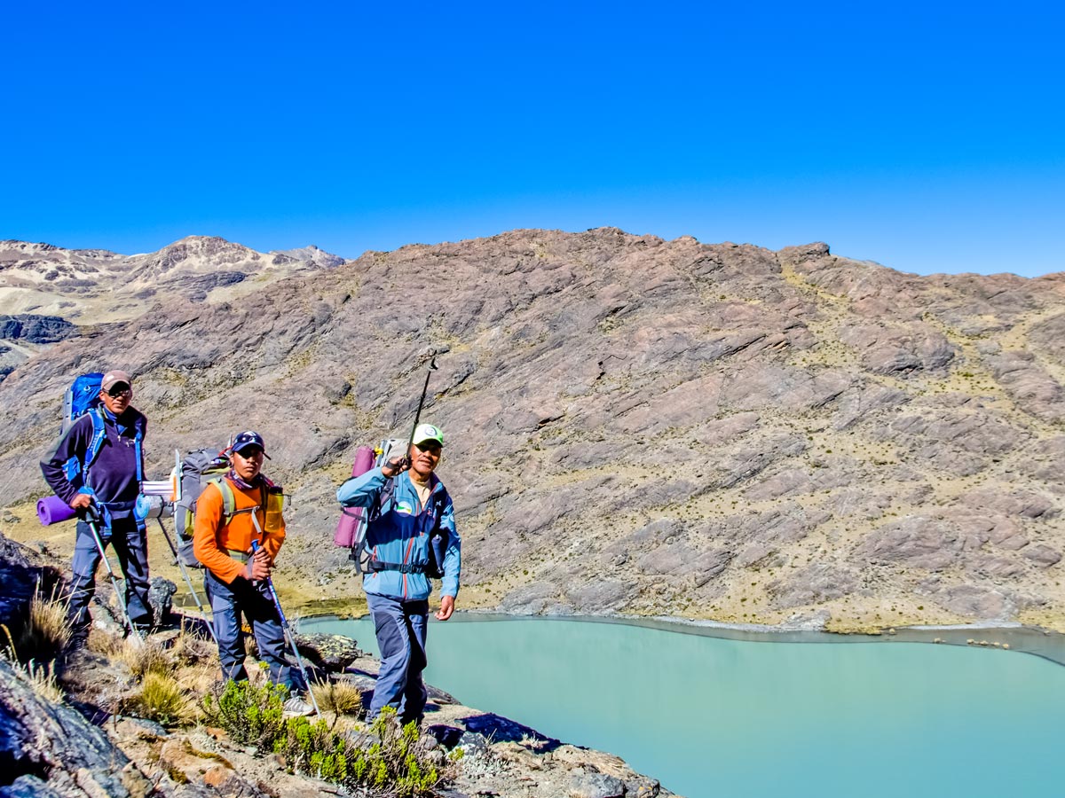 Three hikers near the turquoise lake in the Apolobamba Cordillera - image by V.Kronental