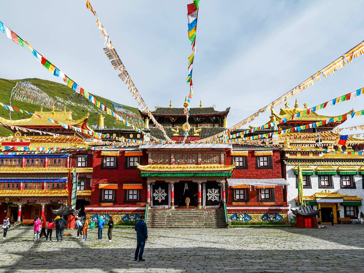 Colorful buildings flags of Tagong Monastery seen while trekking in China