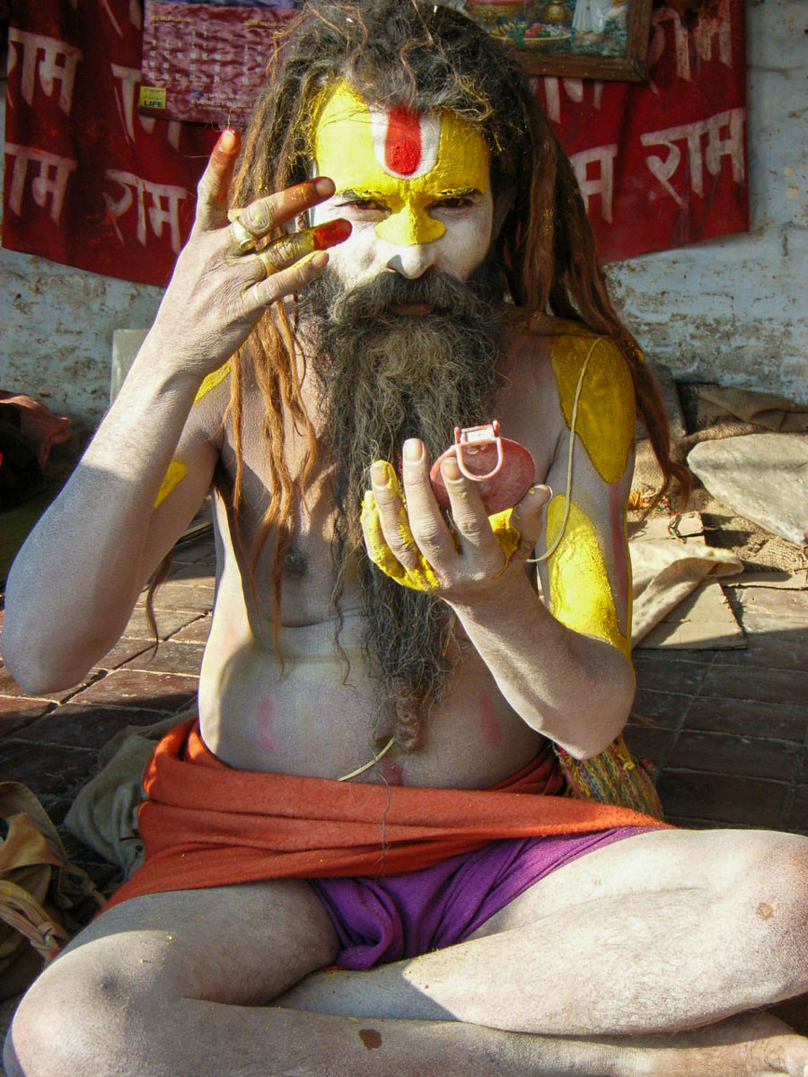 Ascetic Monk applies ceremonial face paint in Kathmandu Tibet