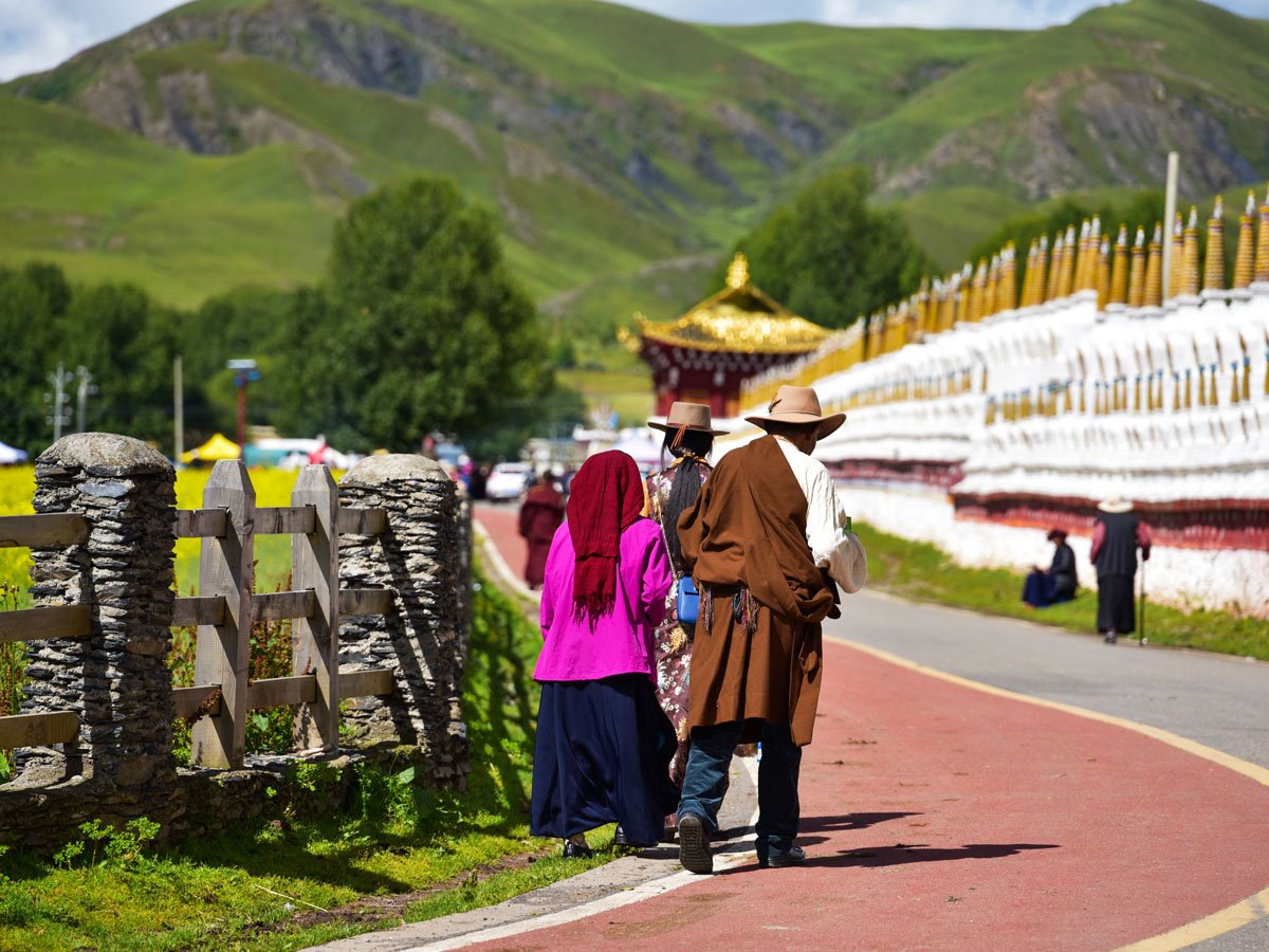 Locals walk by Huiyuan Temple in West Sichuan