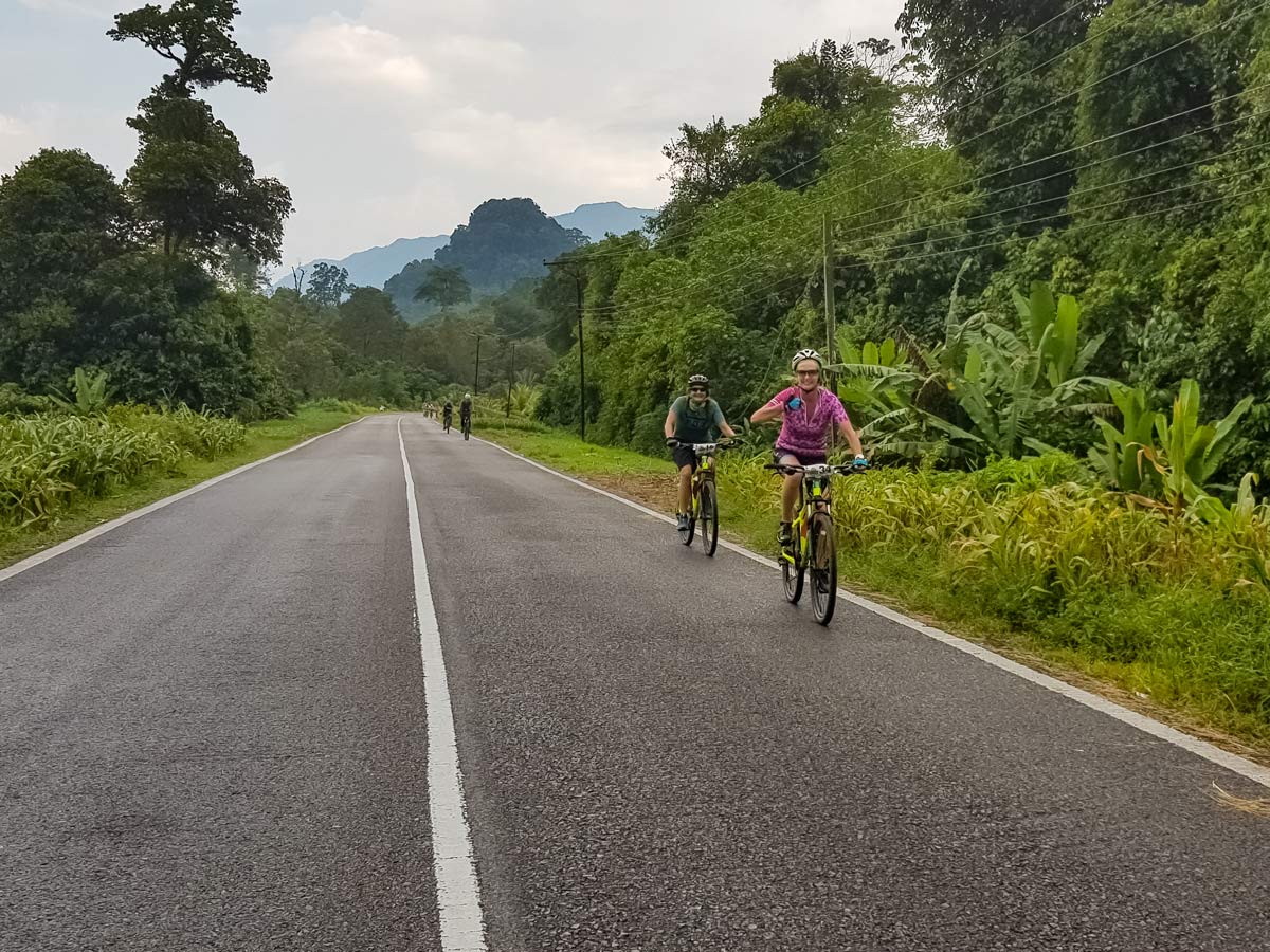 Cyclists road bike along Sarawak Rainforest Adventure tour in Malaysia