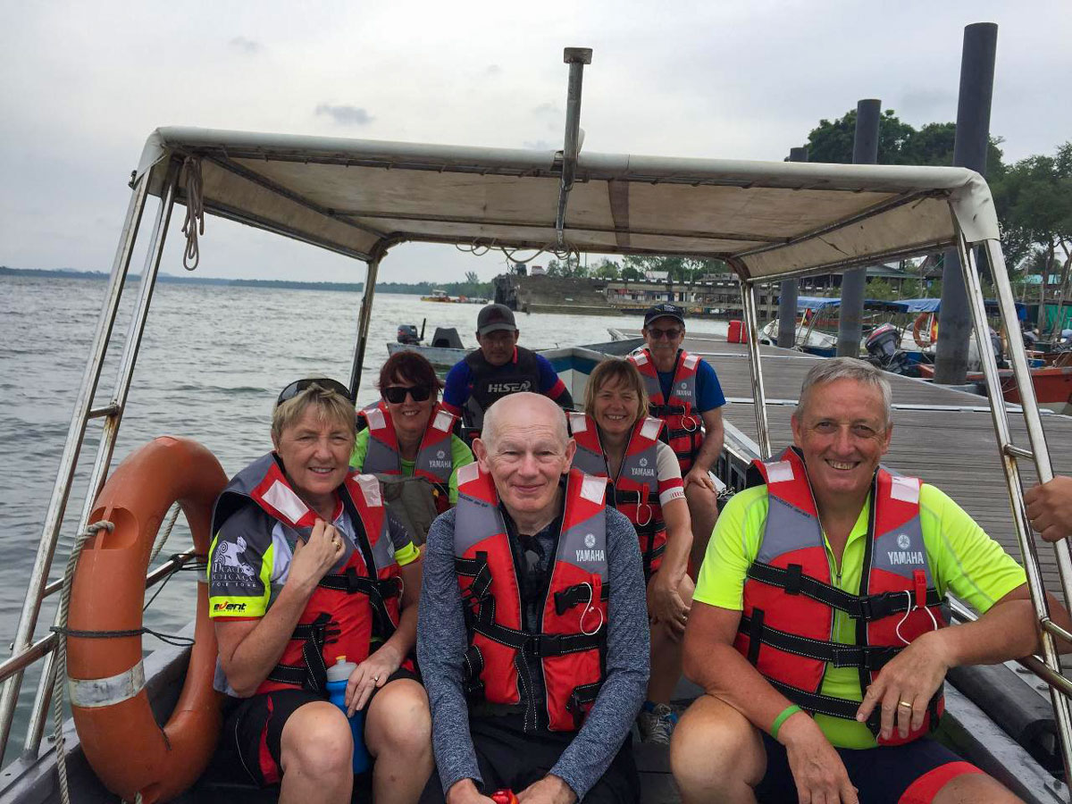 Tourists on boat ride Malaysia Borneo and Island bike tour