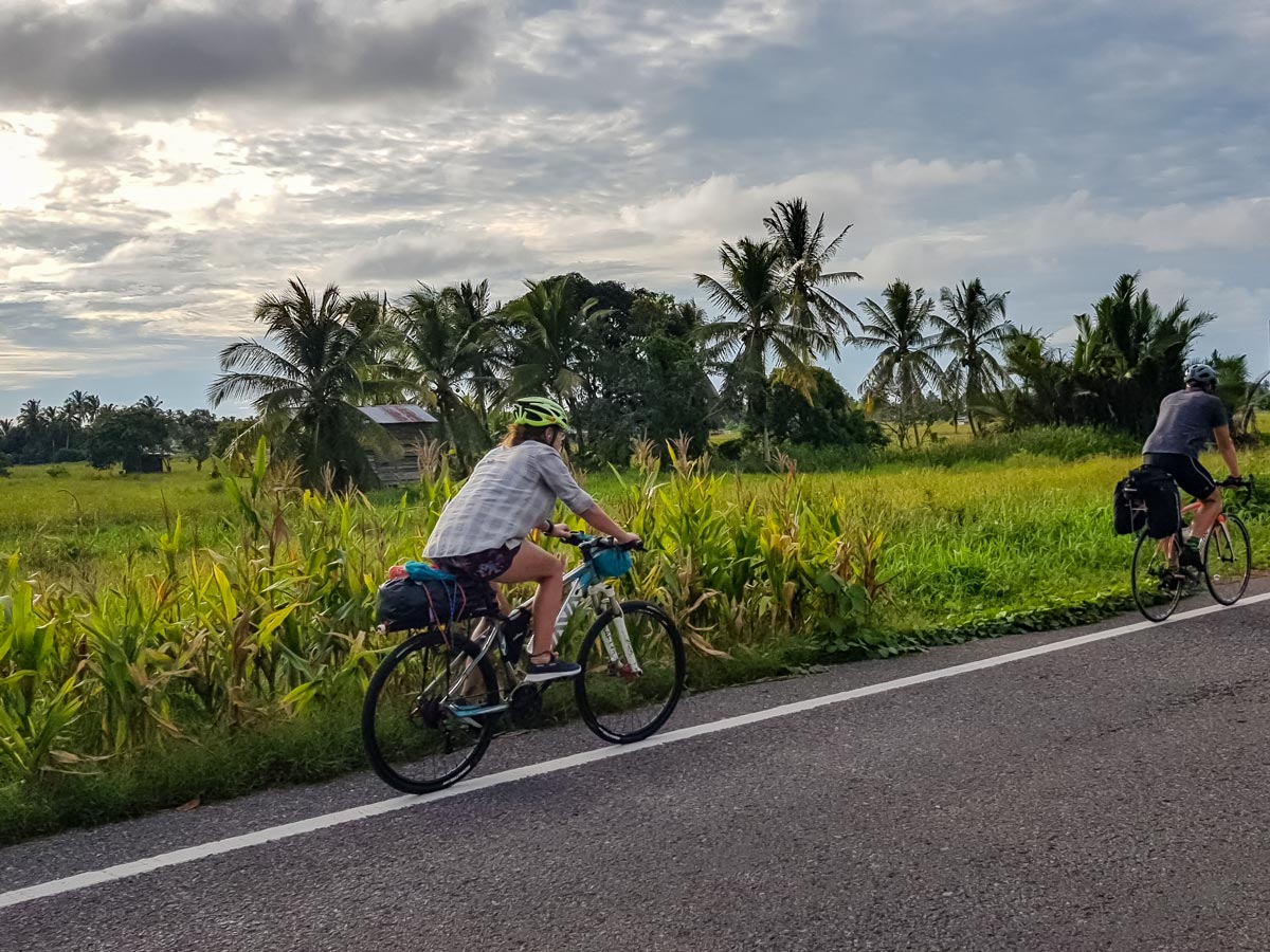 Cyclists road biking along Trans Borneo bike tour in Malaysia