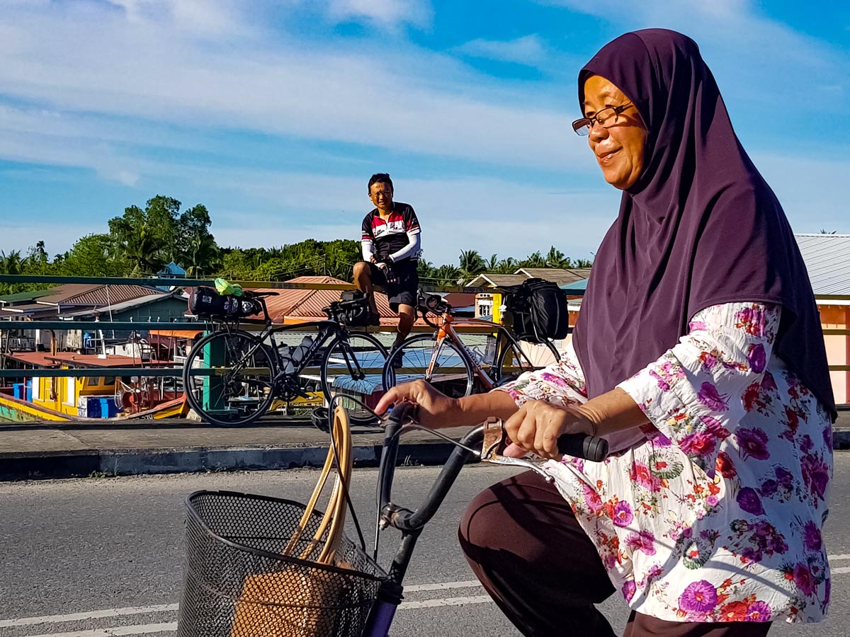 Local woman seen biking along Trans Borneo bike tour Malaysia